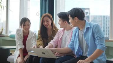 一群亚洲高中生聚集在一个办公室的会议室里，用笔记本电脑查看统计数字，分析市场情况，并考虑开展营销活动.